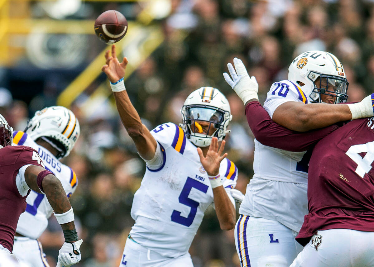 LSU quarterback Jayden Daniels (5) throws during an NCAA college football game against Texas A& ...