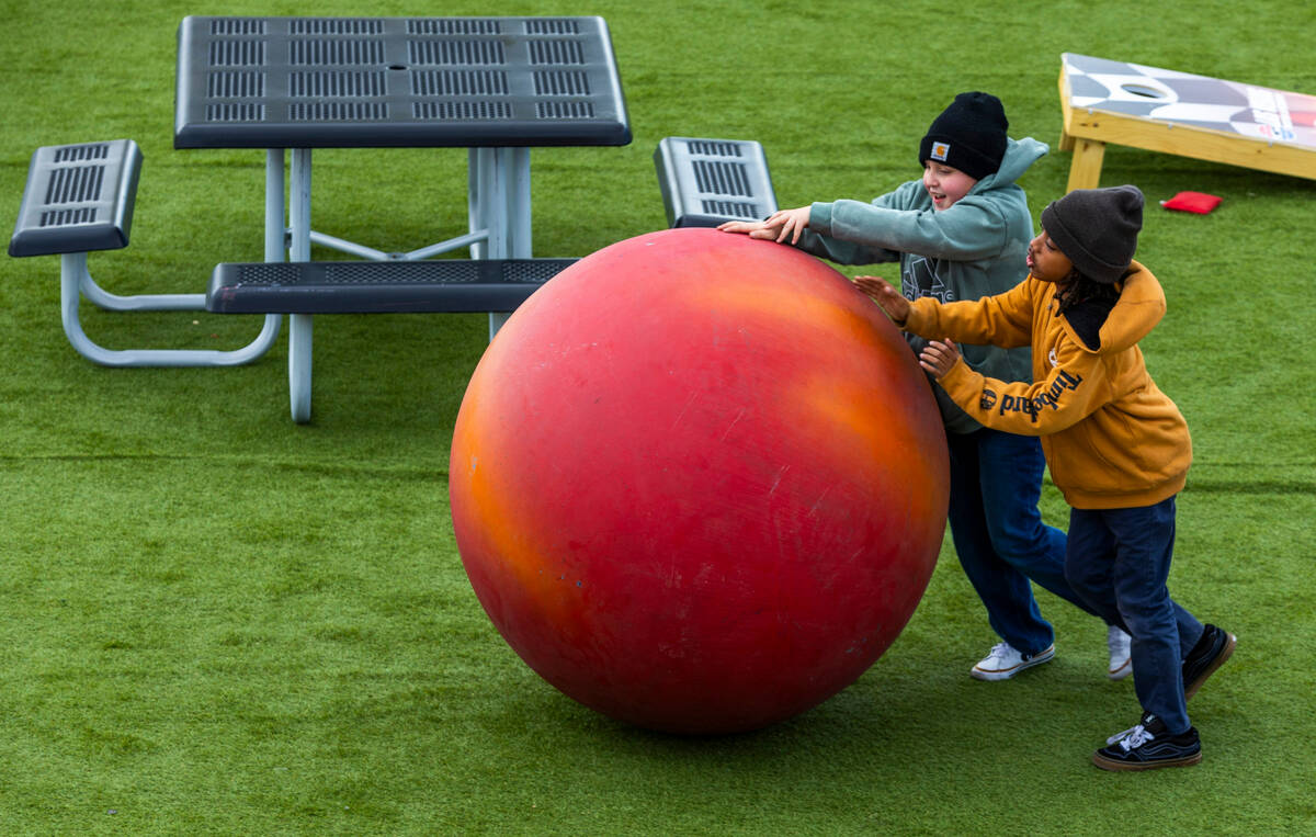 Kids roll a giant ball in a fan zone before the LiUNA NASCAR Xfinity Series race at the Las Ve ...