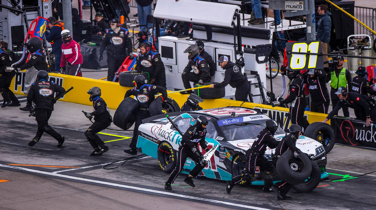 The pit crew changes tires and adds gas as driver Chandler Smith, 81, competes during the LiUNA ...