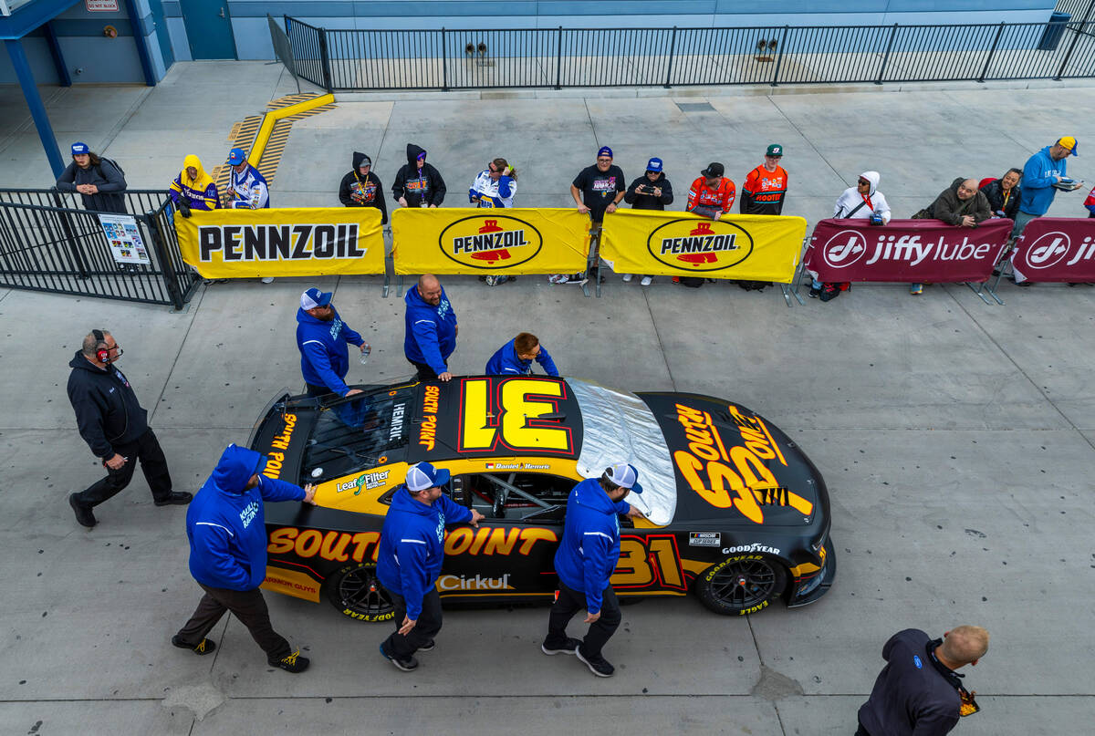 The crew for Daniel Hemric, #31 with team Kaulig Racing Chevrolet, brings his car to the track ...