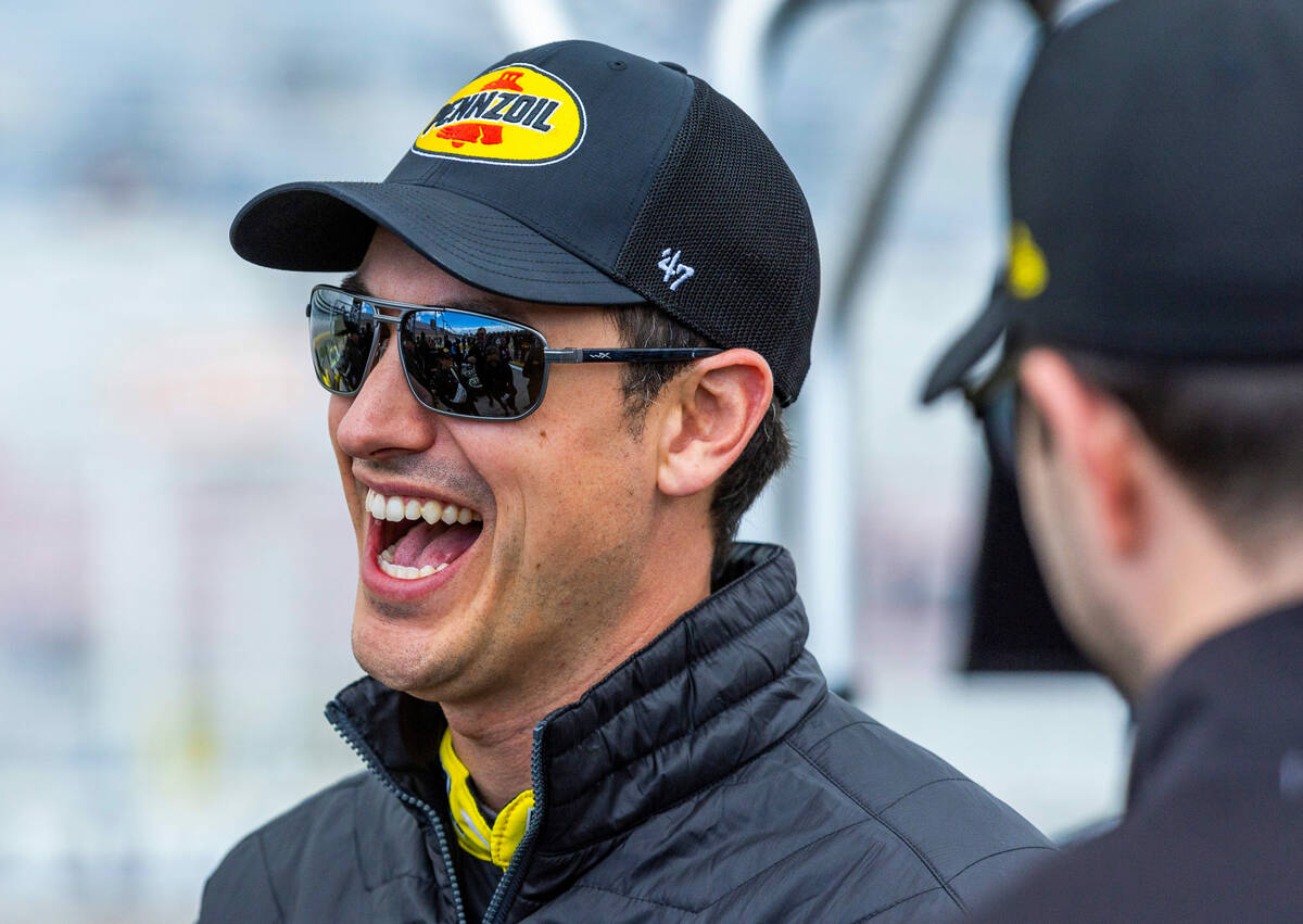 Driver Joey Logano, #22 of Team Penske Ford, shares a laugh in his pit before the Pennzoil 400 ...