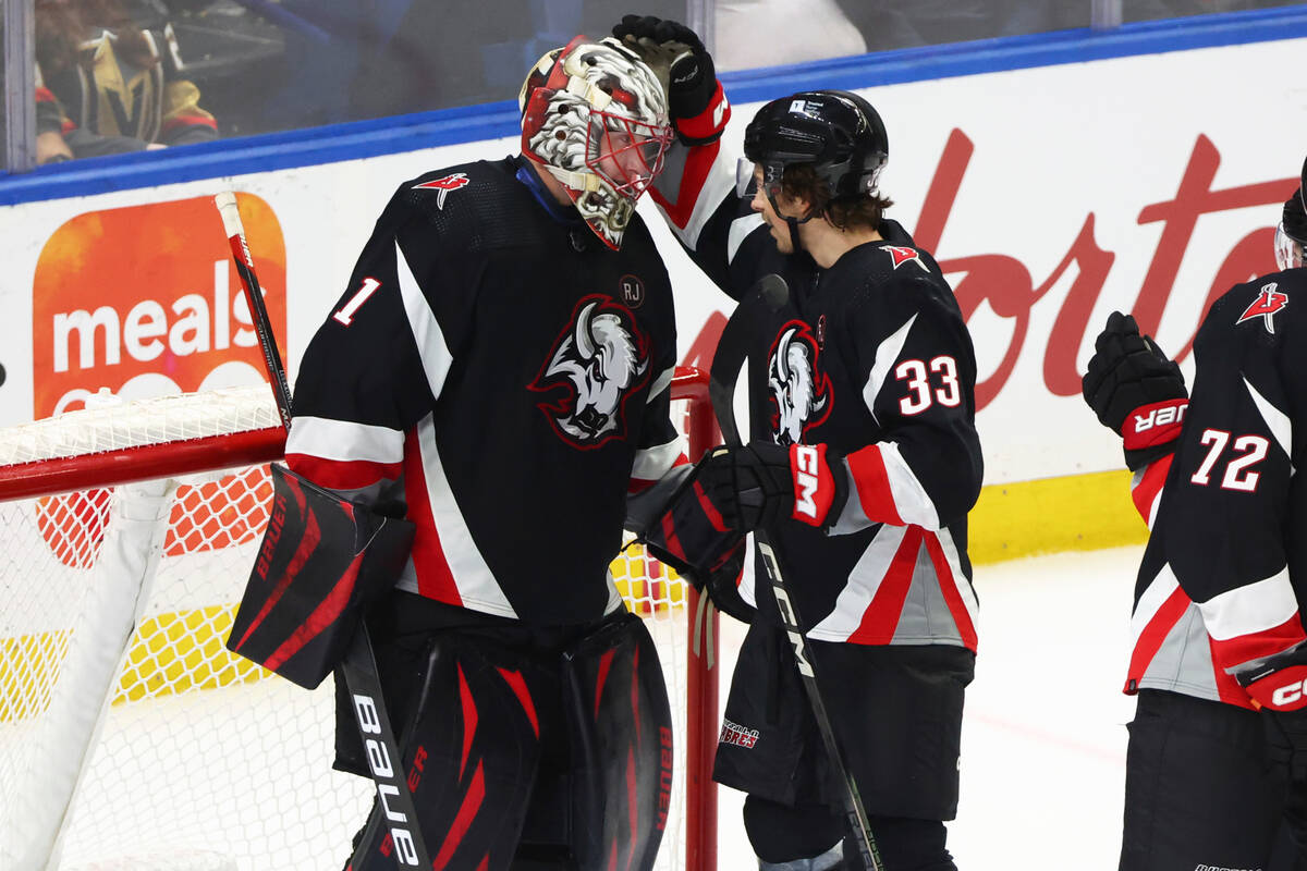 Buffalo Sabres goaltender Ukko-Pekka Luukkonen (1) celebrates with defenseman Ryan Johnson (33) ...