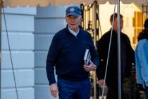 President Joe Biden walks towards members of the media before boarding Marine One on the South ...