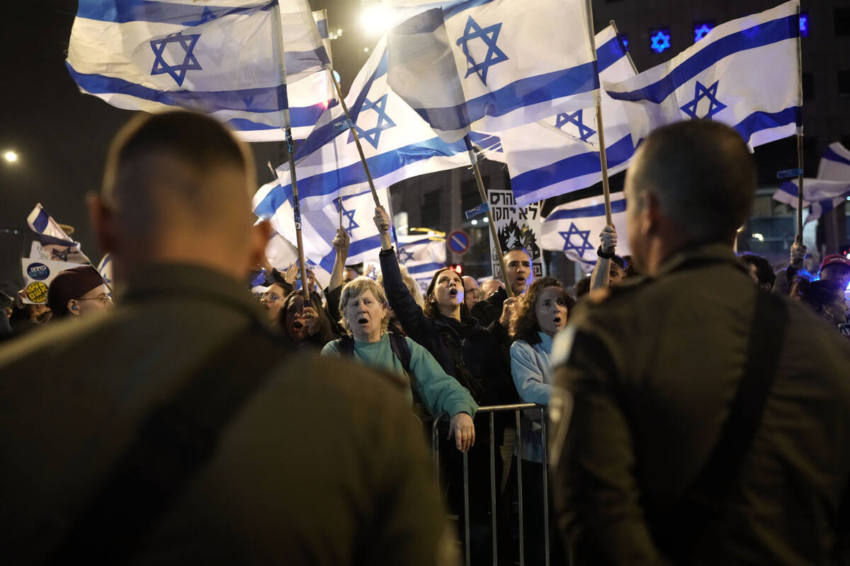 People protest against Israeli Prime Minister Benjamin Netanyahu's government in Tel Aviv, Isra ...