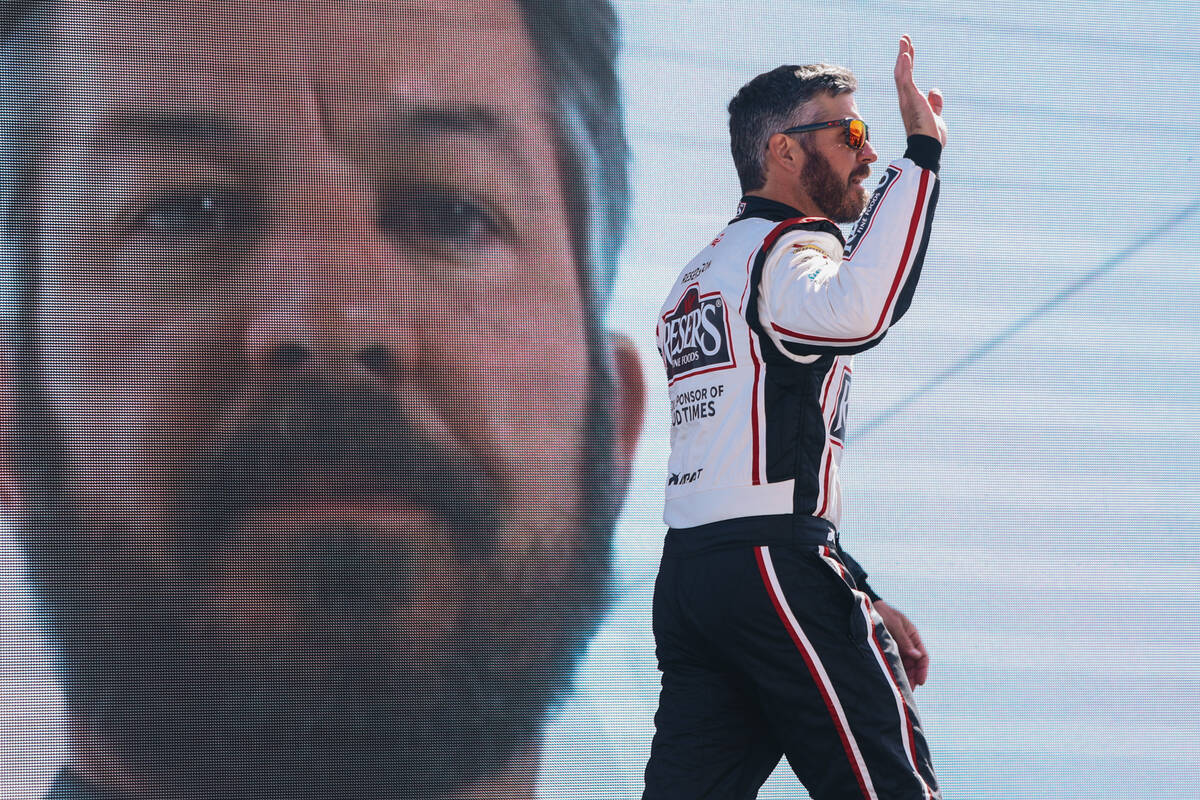 Racer Martin Truex Jr. greets fans during driver introductions at the Pennzoil 400 NASCAR Cup S ...