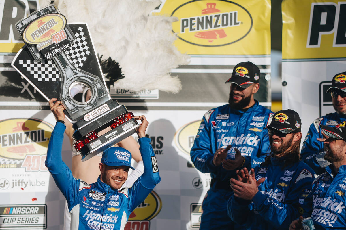 Kyle Larson holds up a trophy after winning the Pennzoil 400 NASCAR Cup Series race at the Las ...