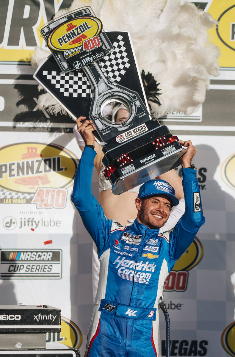Kyle Larson holds up a trophy after winning the Pennzoil 400 NASCAR Cup Series race at the Las ...