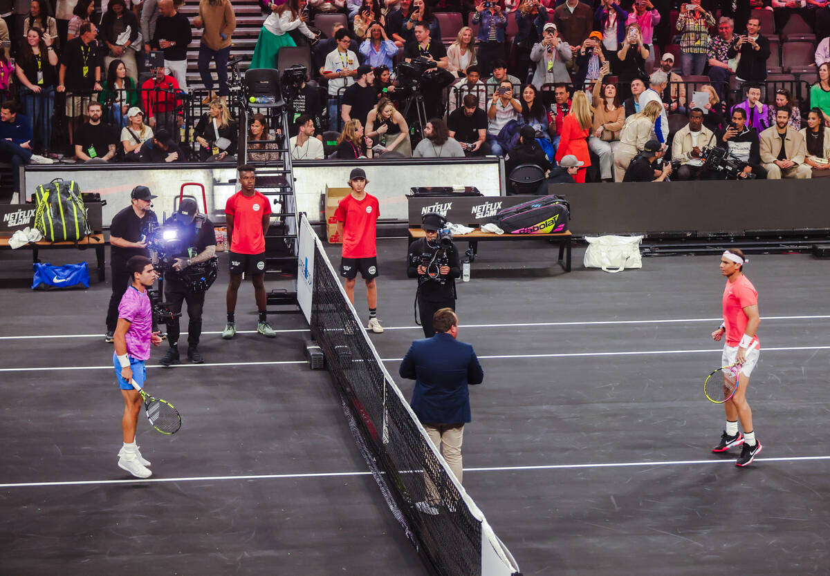 Carlos Alcaraz, left, prepares to play against Rafael Nadal, right, at the Netflix Slam, a live ...