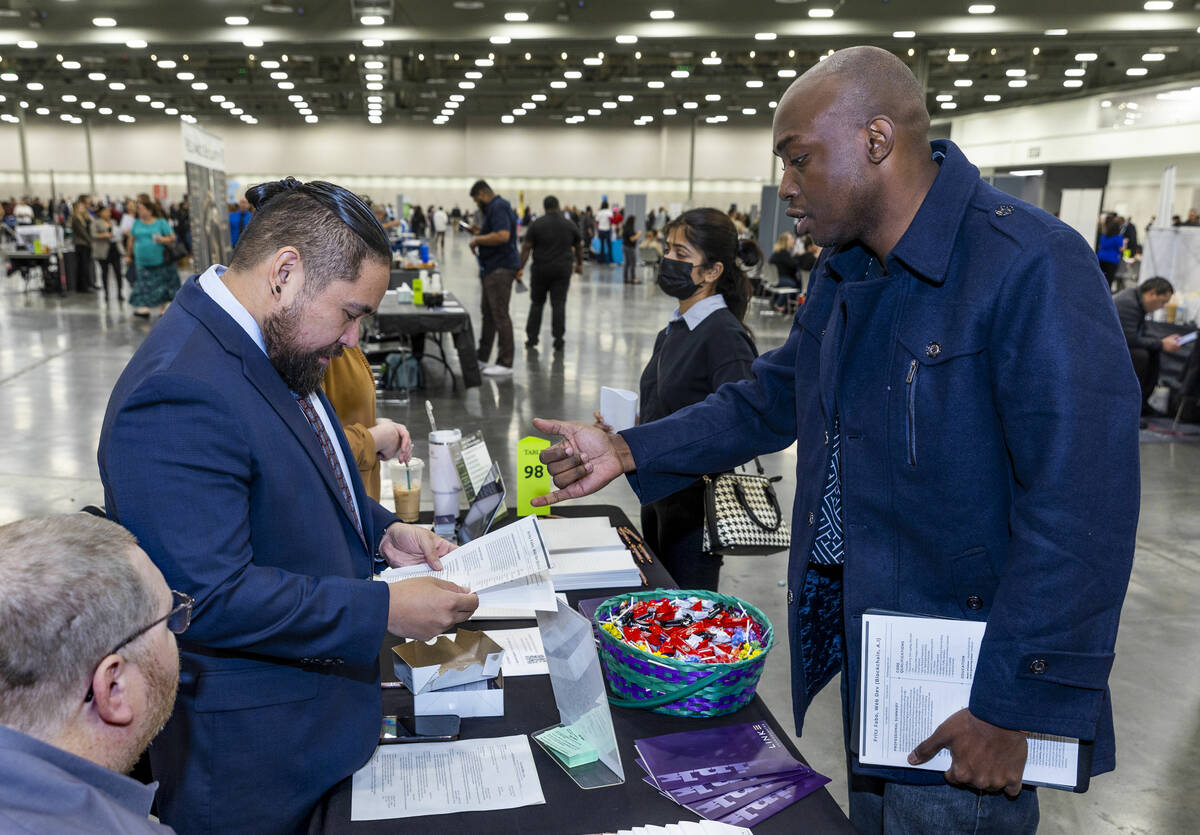 Link Technologies technical recruiter Ryan Balbido, left, pours over the resume of job seeker F ...