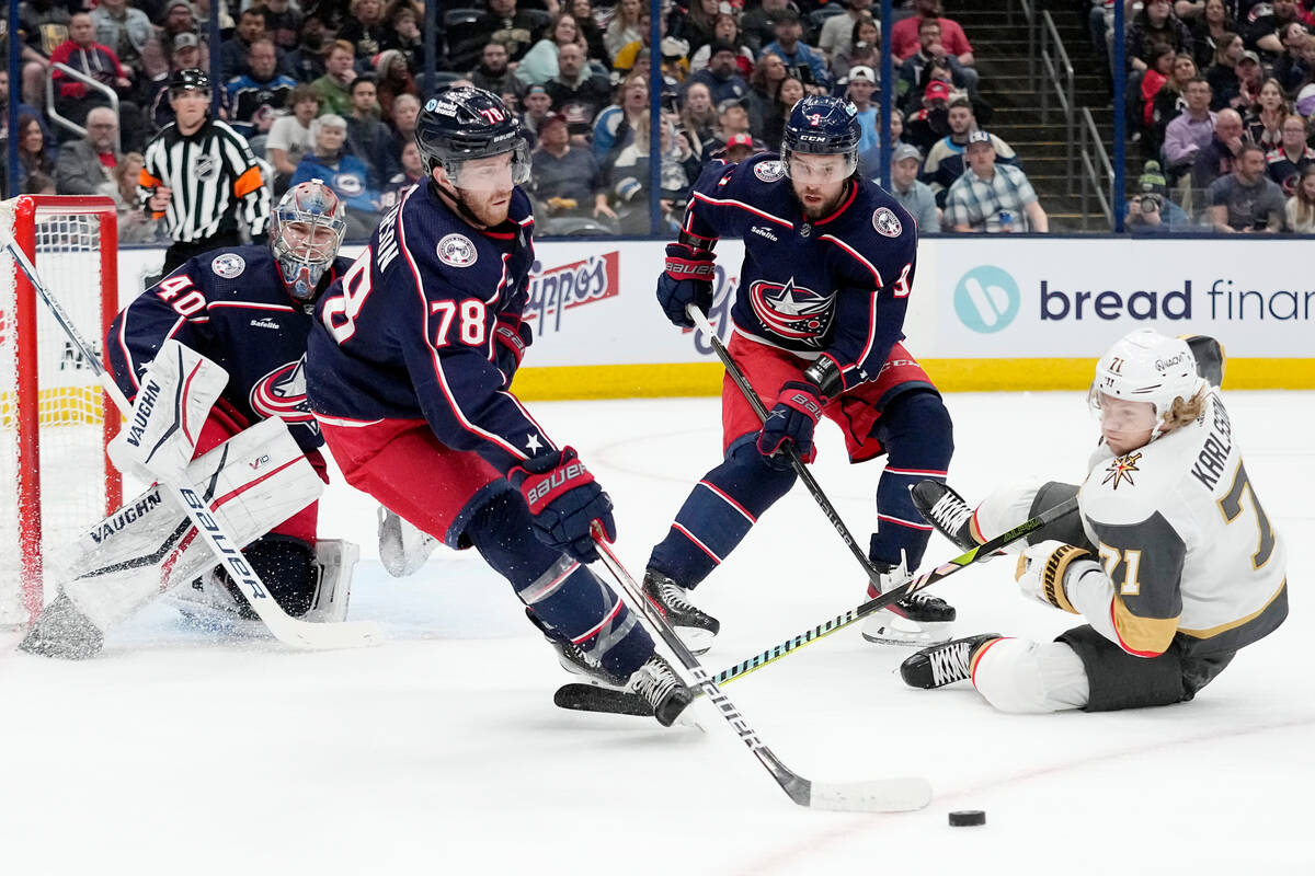 Columbus Blue Jackets defenseman Damon Severson (78) clears the puck from in front of Daniil Ta ...