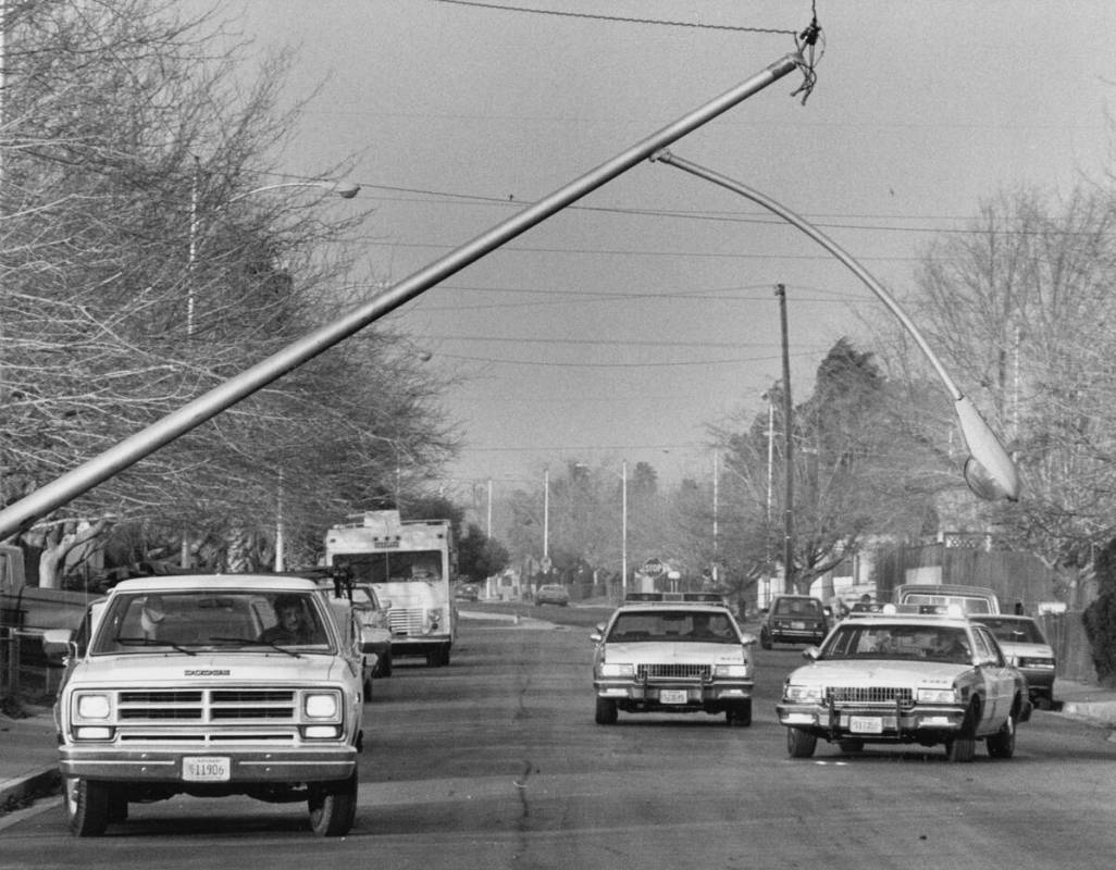 A light pole is seen blown down by the wind near Washington Avenue and Pecos Road December 19, ...