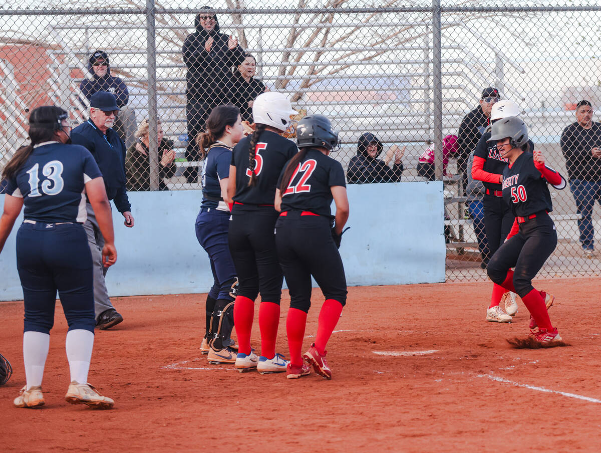 Liberty High School’s Jaydah Chun (50) is cheered by her teammates as she sets to pass h ...