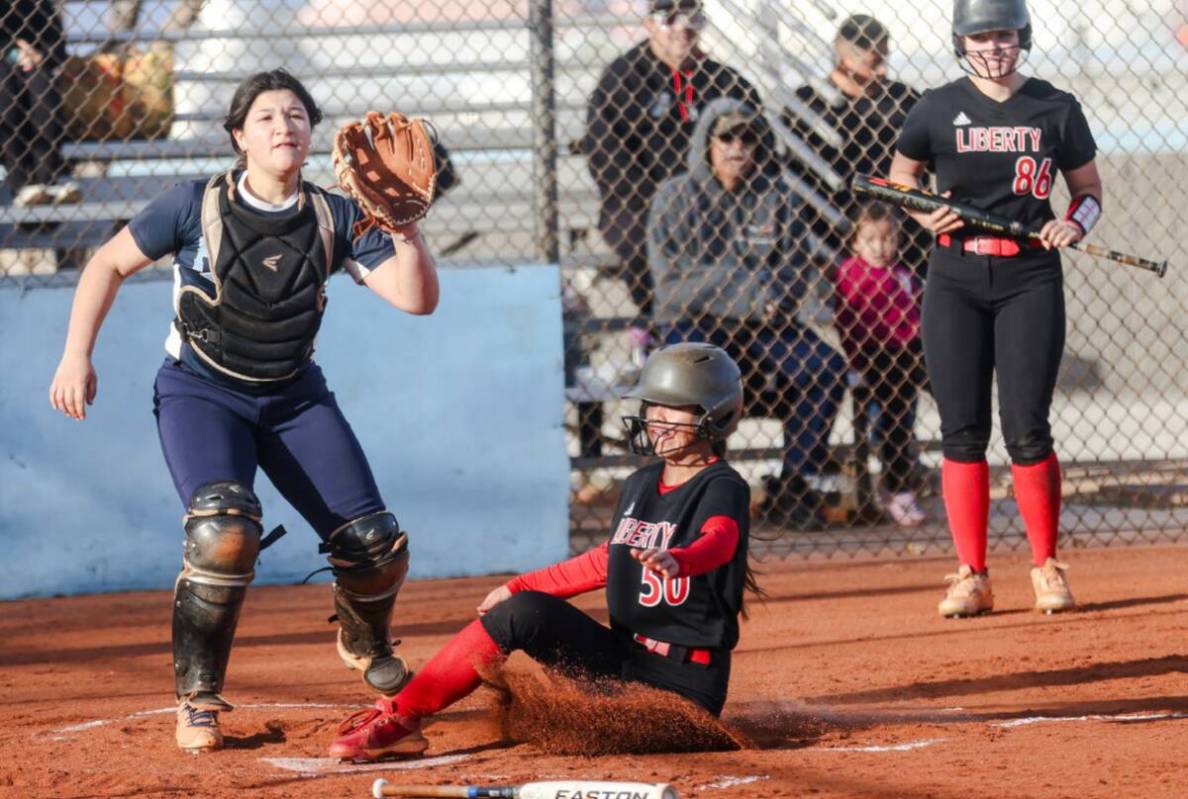 Liberty High School’s Jaydah Chun (50) slides over home base against Foothill High School dur ...