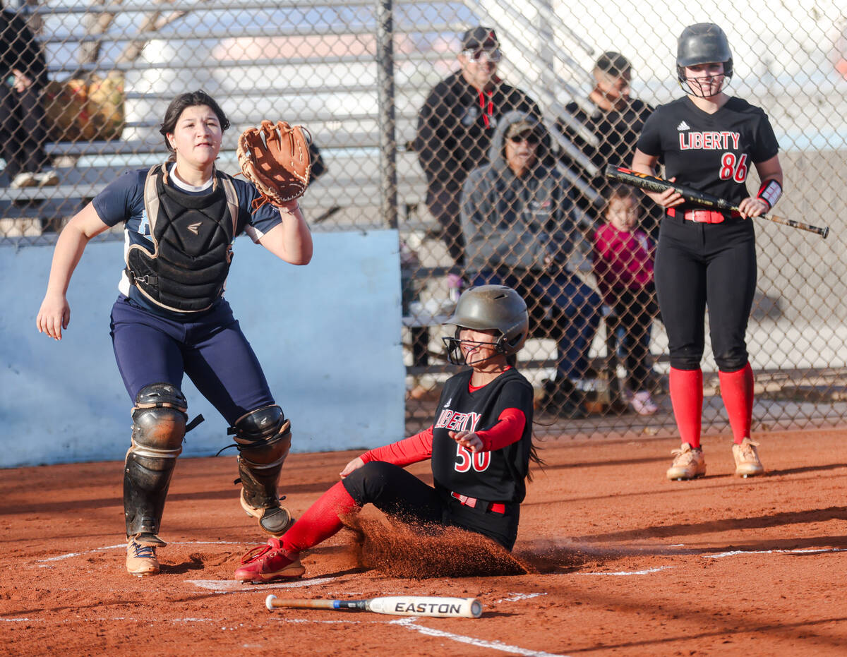 Liberty High School’s Jaydah Chun (50) slides over home base against Foothill High Schoo ...