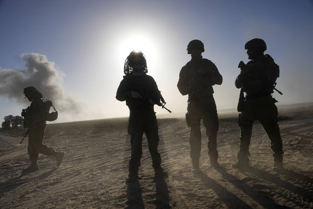 Israeli soldiers are seen near the Gaza Strip border in southern Israel, Monday, March 4, 2024. ...