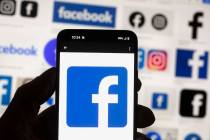 The Facebook logo is seen on a cell phone in Boston, USA, Oct. 14, 2022. Users of Meta's Facebo ...