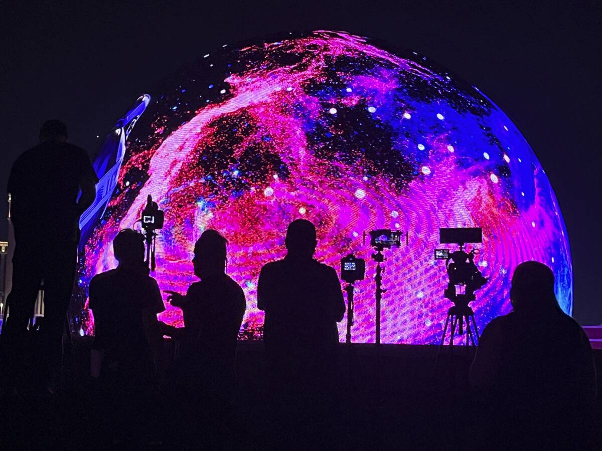 People watch and film Sphere during the July 4th unveiling of the Exosphere programming. (James ...