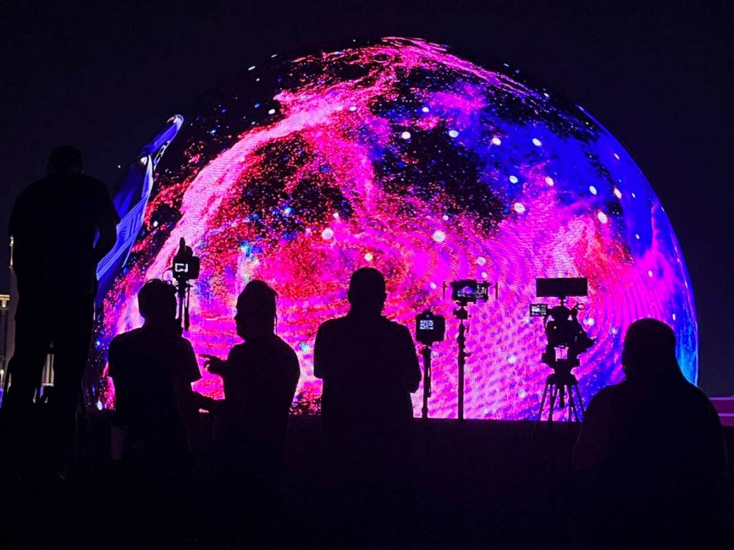 People watch and film Sphere during the July 4th unveiling of the Exosphere programming. (James ...