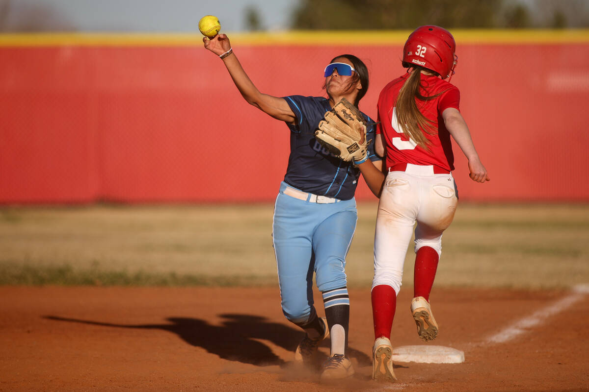 Centennial's Hailey Smith (9) throws to home after outing Arbor View's Hannah Escobedo (32) dur ...