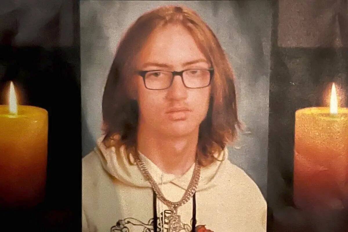 A photo of Jonathan Lewis Jr. is seen on a poster at a vigil held in Las Vegas on November 22, ...