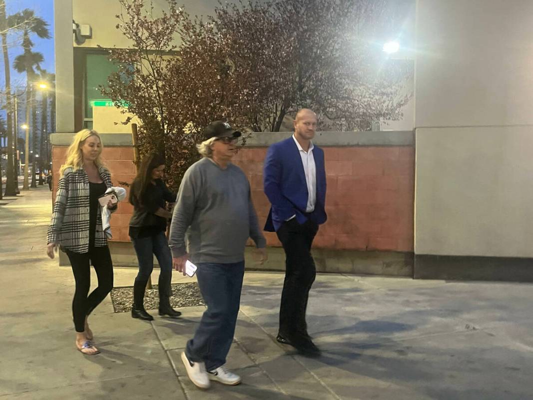 Daniel Rodimer, right, arrives at the Clark County Detention Center to be booked on Wednesday, ...