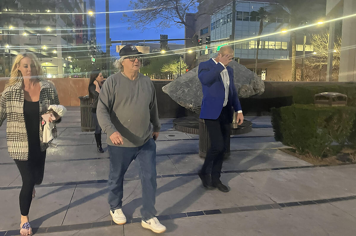 Daniel Rodimer, right, walks into the front entrance of the Clark County Detention Center with ...