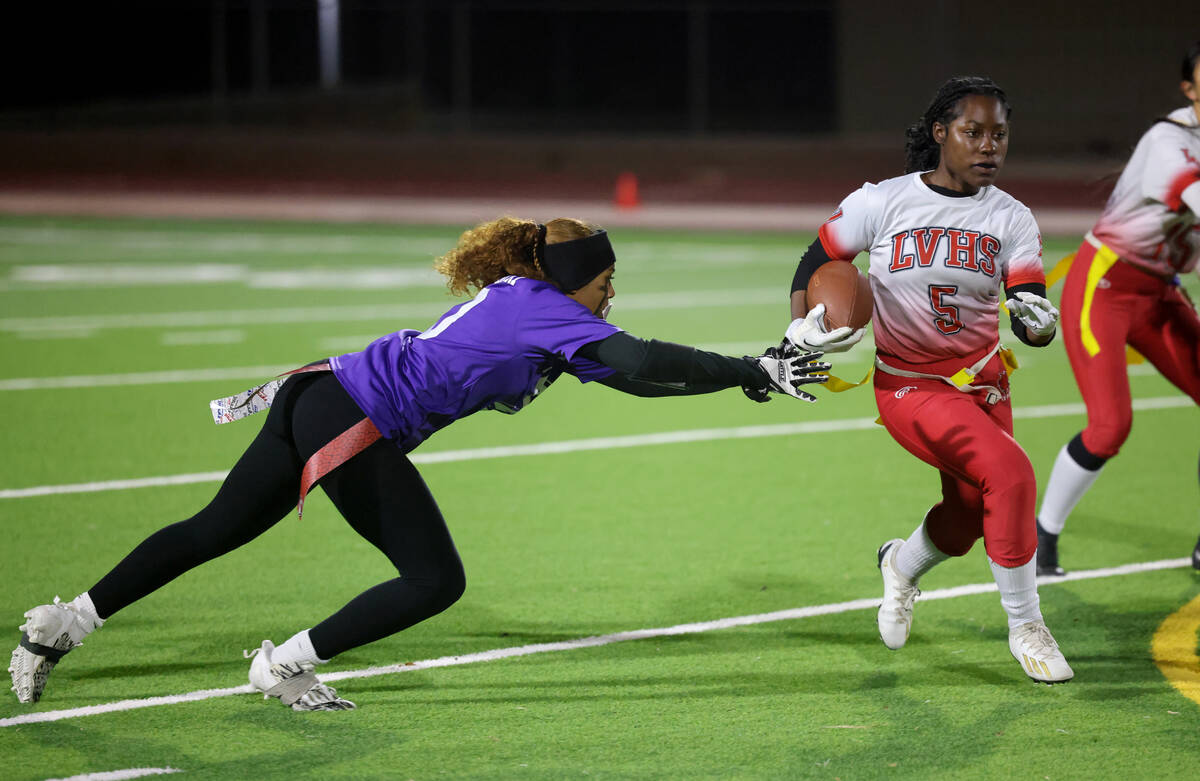 Las Vegas’ Antonia Woods (5) runs past Desert Oasis defender Brooklin Hill (10) in the s ...