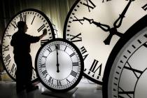 Electric Time Co. employee Walter Rodriguez cleans the face of an 84-inch Wegman clock at the p ...