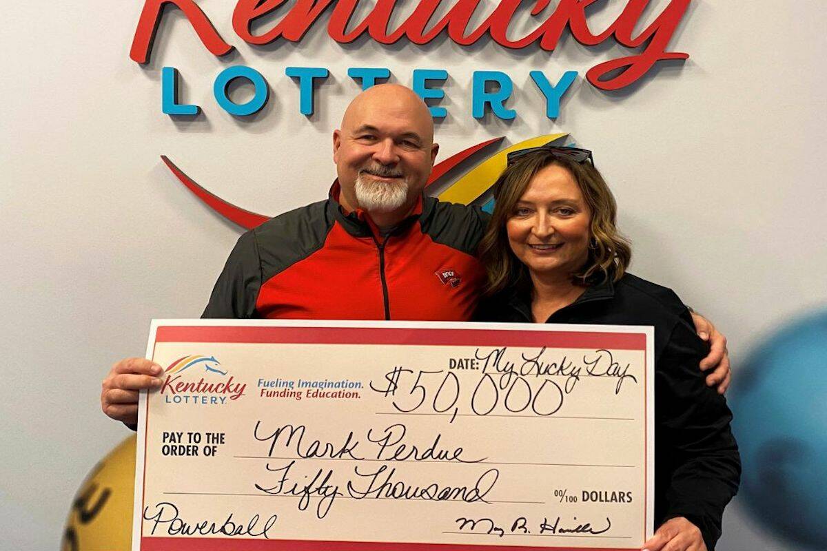 In this recent image provided by Kentucky Lottery, Mark Perdue and his wife pose at the Kentuck ...