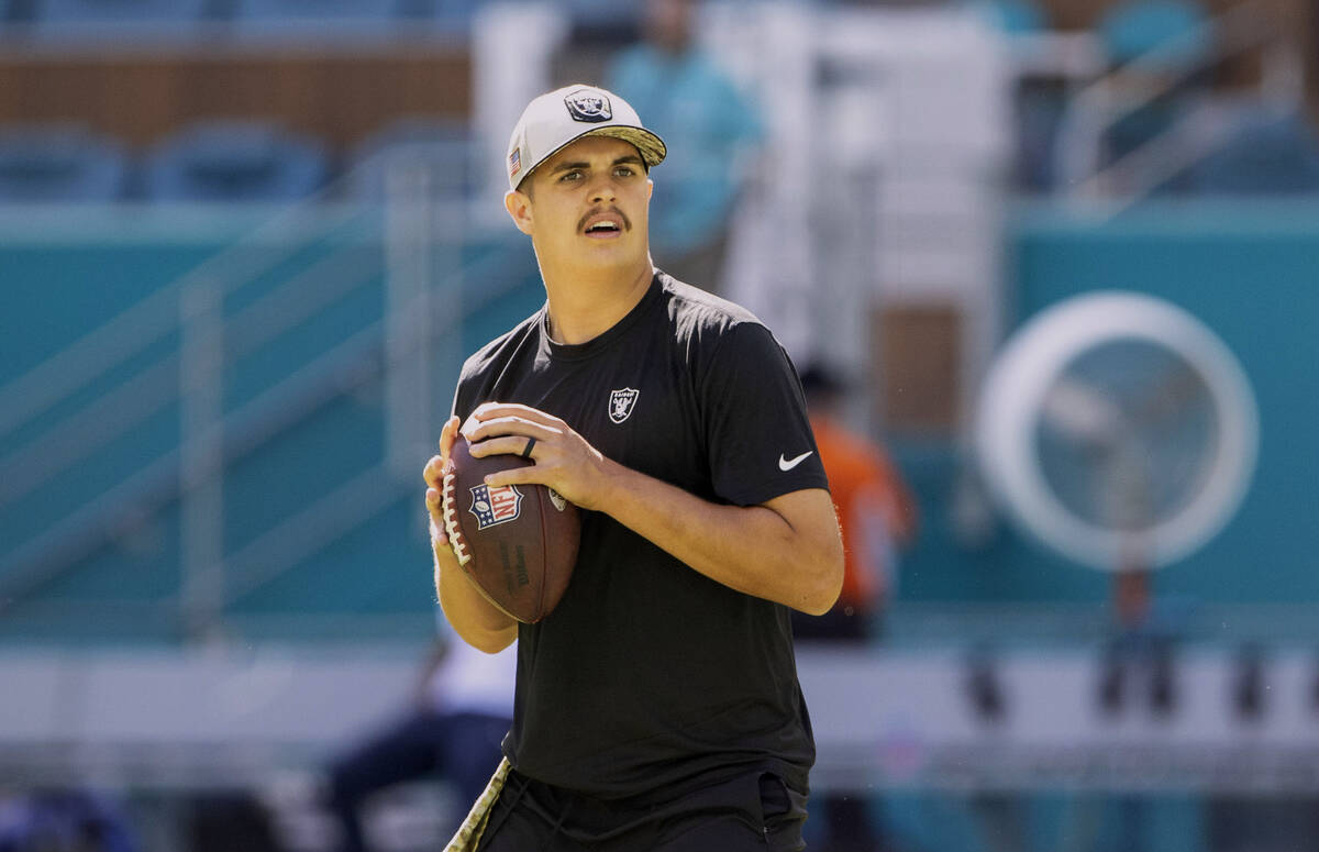 Raiders quarterback Aidan O'Connell warms up before an NFL game against the Miami Dolphins on S ...