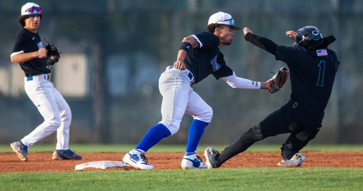 Green Valley infielder Caden Kirby (12) readies to tag out Silverado runner Tristan Hudson (1) ...