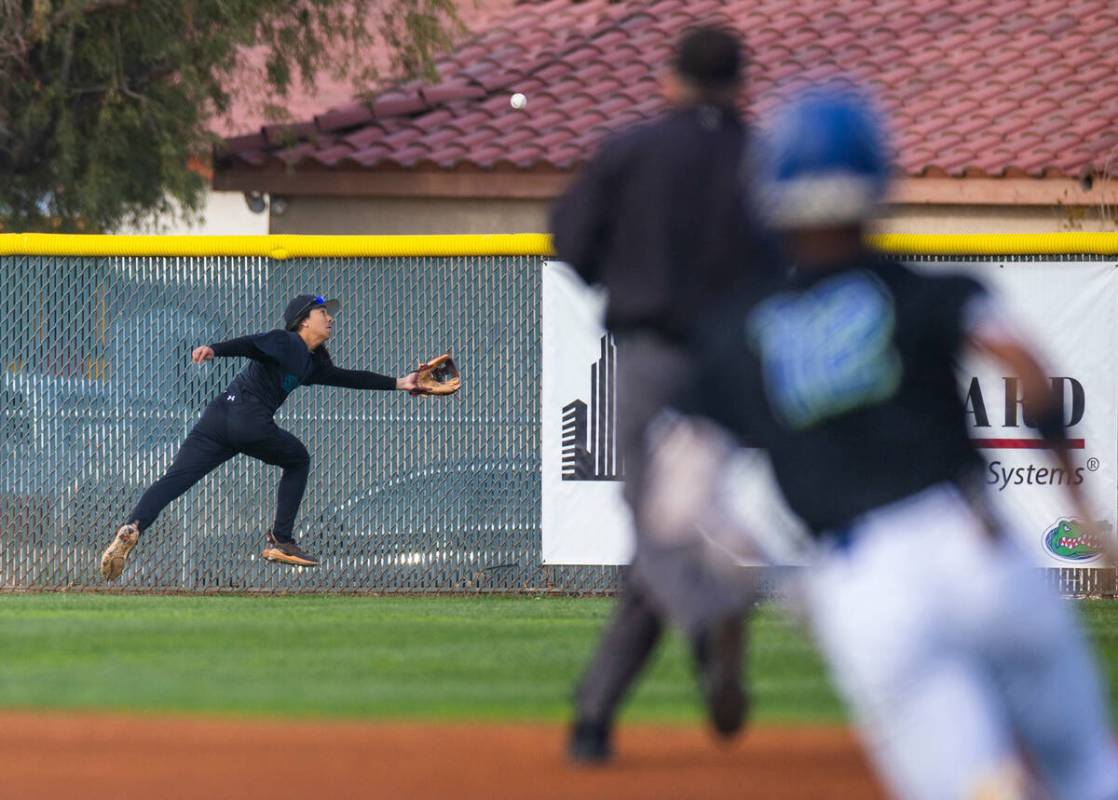 Silverado outfielder Kanoa Wolfgang (5) chases a long fly ball as Green Valley batter Caden Kir ...