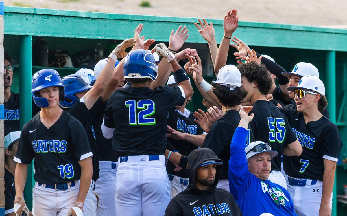 Green Valley batter Caden Kirby (12) is congratulated on a run by teammates against Silverado d ...