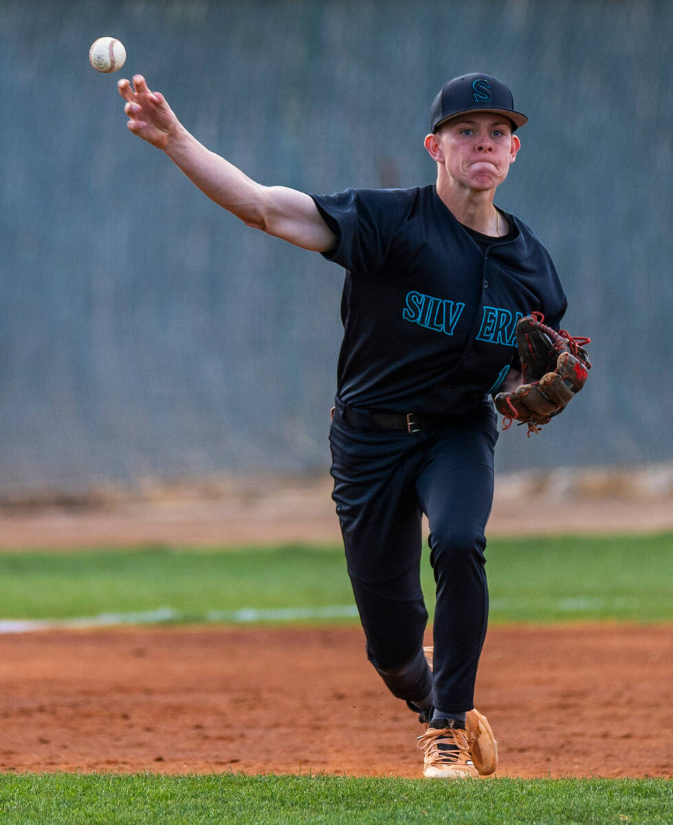 Silverado infielder Preston Clark (12) throws the ball to first base for a Green Valley out dur ...