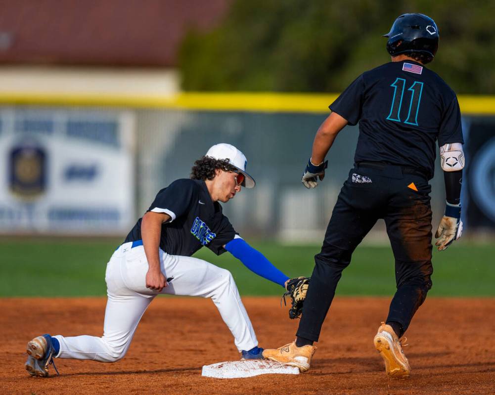 Green Valley infielder Jacob Ferry (3) gets the tag late on Silverado runner Jayden Orphan (11) ...