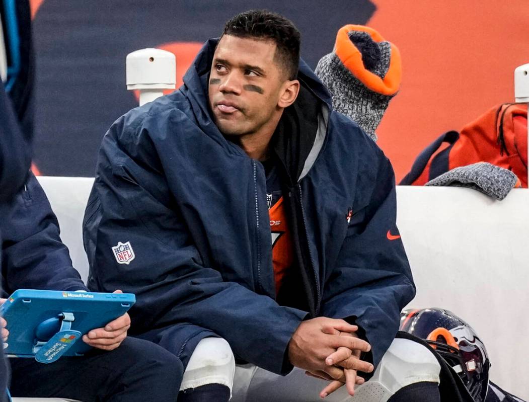 FILE - Denver Broncos quarterback Russell Wilson sits on the bench during the second half of an ...