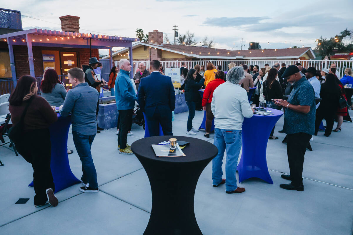 People mingle during an opening for the Nevada Partnership for Homeless Youth Outreach, Volunte ...