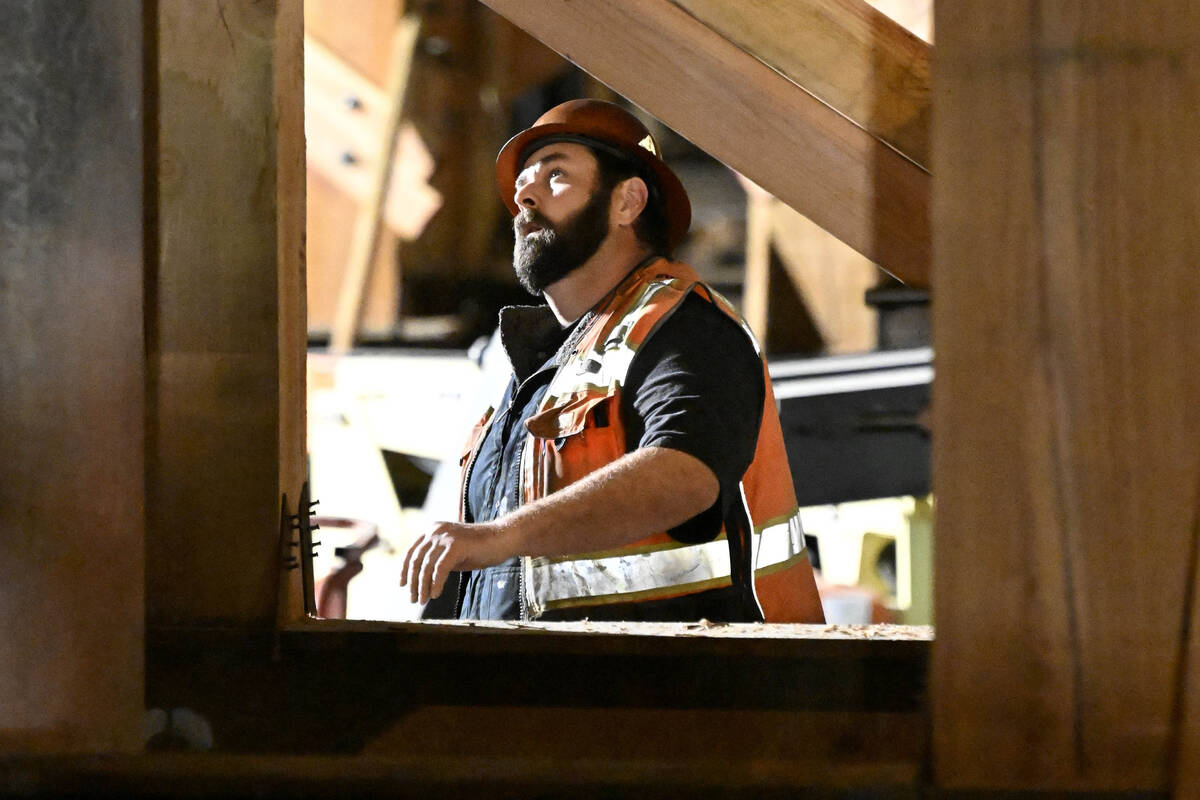 FILE - A construction worker looks up at the I-10 freeway, which was closed by fire on Nov. 19, ...