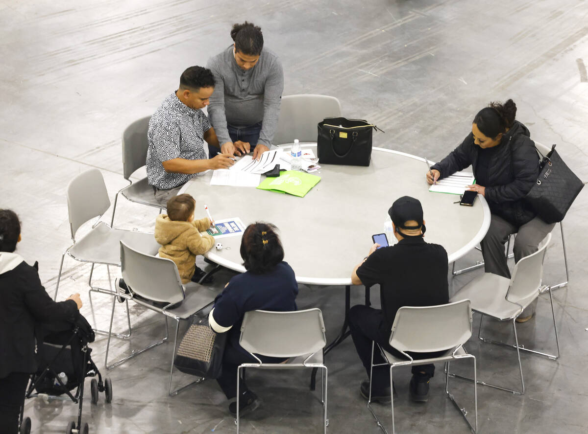 Job seekers fill out applications during the annual Spring Job Fair at the Las Vegas Convention ...