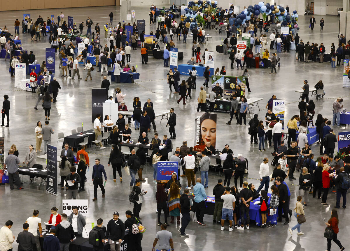 Job seekers visit booths during the annual Spring Job Fair at the Las Vegas Convention Center, ...