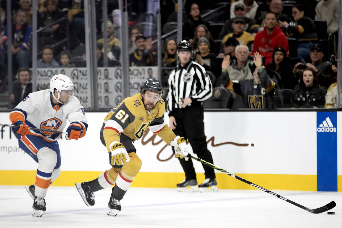 Golden Knights right wing Mark Stone (61) looks to pass while skating against Islanders defense ...