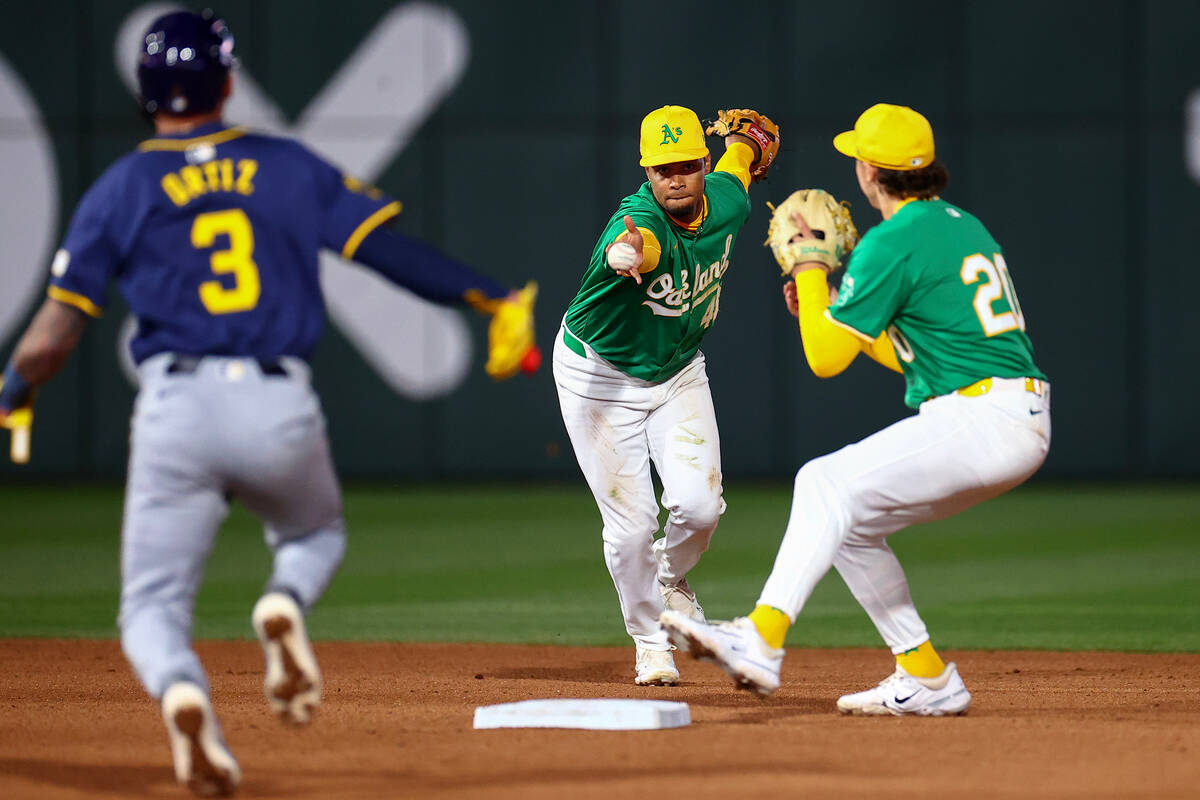 Oakland Athletics shortstop Darell Hernaiz (48) passes the ball off to second baseman Zack Gelo ...