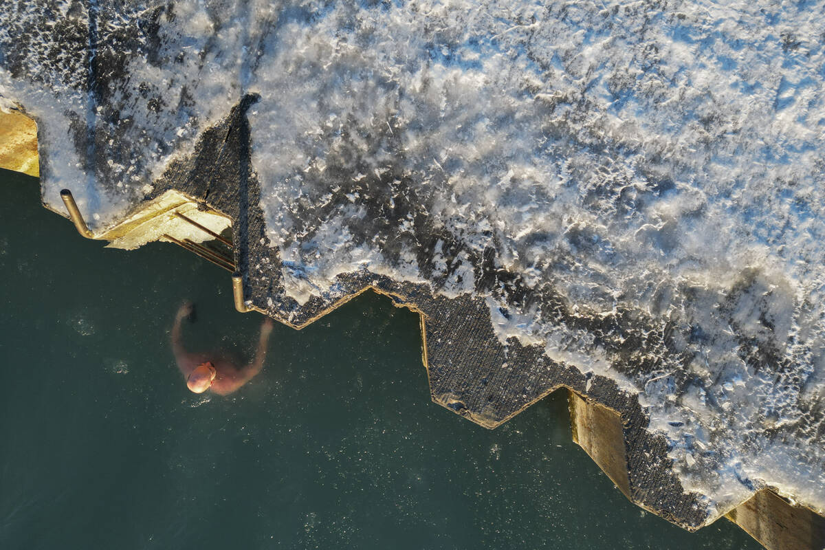 FILE - George Miller climbs out of the icy waters of Lake Michigan, Feb. 2, 2023, in Chicago. F ...