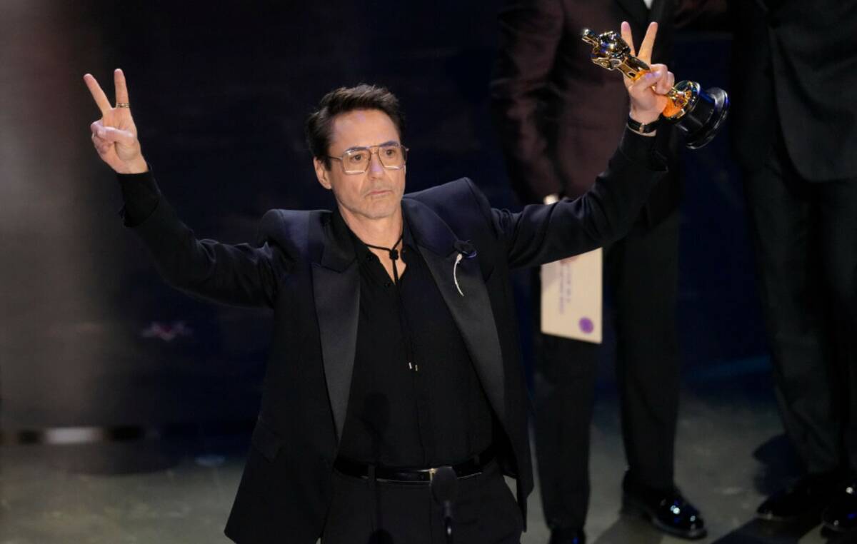 Robert Downey Jr. accepts the award for best performance by an actor in a supporting role for " ...