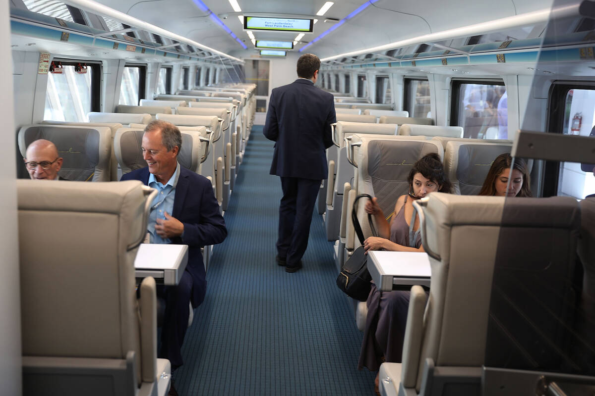 People take their seats on the Brightline passenger train's inaugural trip from Miami to West P ...