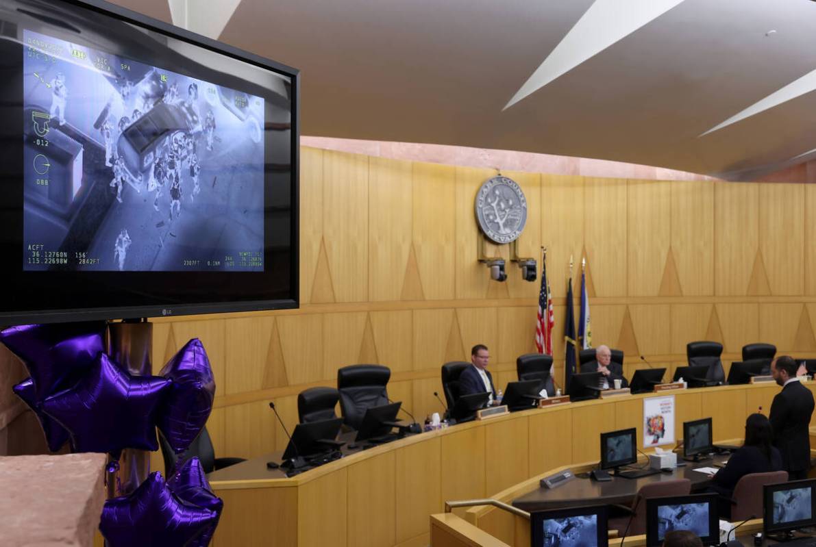 Police video is shown as Detective Jason Leavitt, left, testifies during a fact-finding review ...