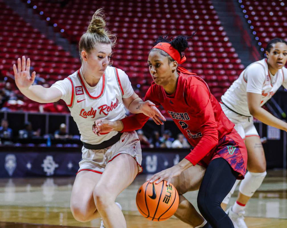 Fresno State’s guard Keely Brown (2) tries to push past UNLV’s guard Ashley Scogg ...