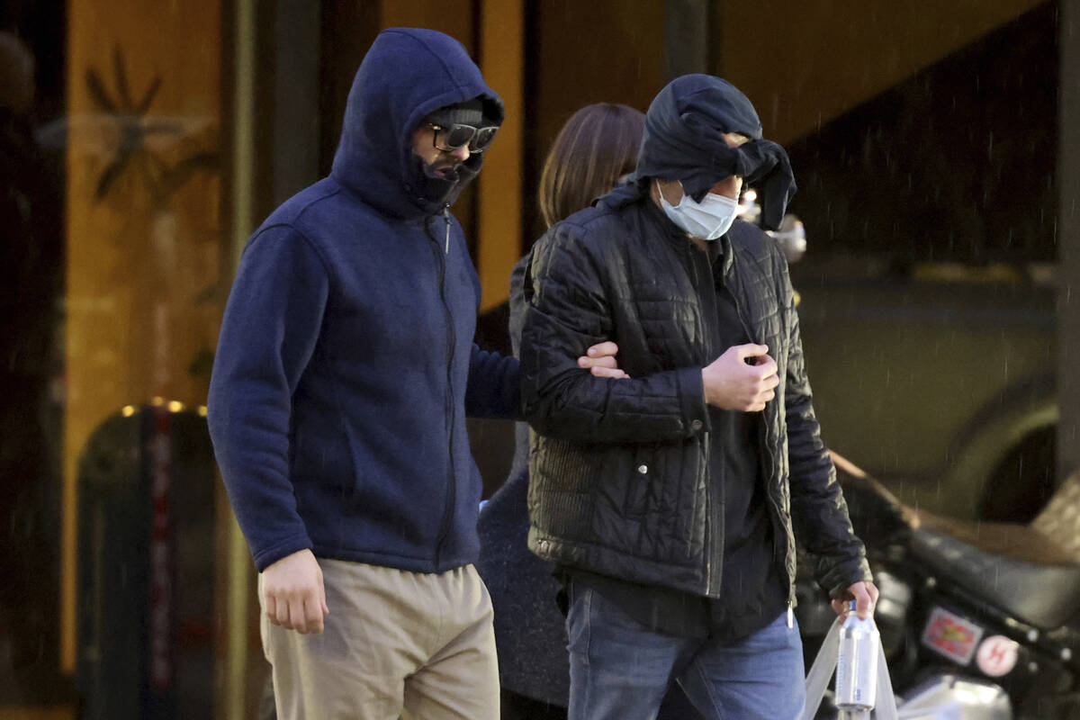 Former FBI informant Alexander Smirnov, left, walks out of his lawyer's office in downtown Las ...