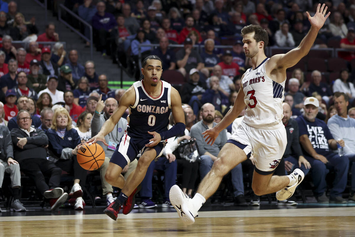 Gonzaga Bulldogs guard Ryan Nembhard (0) drives toward the hoop against St. Mary's Gaels guard ...