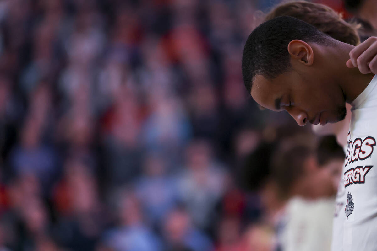 Gonzaga Bulldogs guard Nolan Hickman (11) bows his head during the national anthem before an NC ...